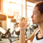 Girl drinking water at a gym