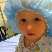 Isabella wears a surgical hair cover before surgery at Children's Hospital Colorado.