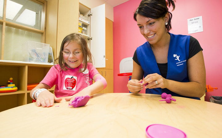 Child and volunteer in the Creative Play Center at Children’s Colorado