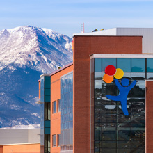 A photo showing the new Children's Hospital Colorado, Colorado Springs in front of the mountains.