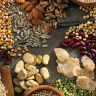 A array of foods including rice, dried cranberries, corn kernels, almonds, kidney beans and flaxseed.