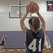 A girl prepares to inbound the basketball during a practice game.