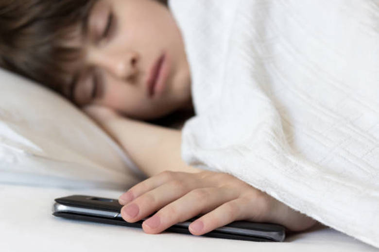 child sleeping with phone