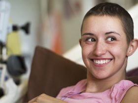 Close-up of adolescent cancer patient smiling